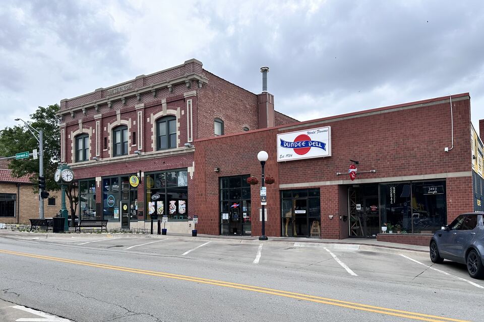 Two-story brick commercial buildings with storefronts at a street corner in Dundee's business district.